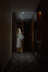 Barefoot Woman with white Bathrobe open the Door