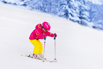 Little girl skiing in the mountains
