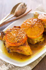 fried chicken with orange on white dish