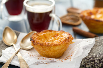 portuguese dessert pastel de nata with cup of coffee on blue wooden background