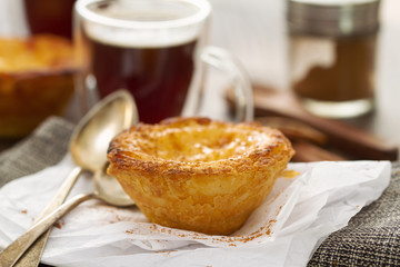 traditional portuguese dessert pastel de nata with cup of coffee