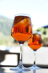two glasses with a cocktail Aperol in a street cafe in Italy