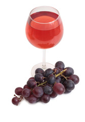 Bottle glass of wine and grapes on white background