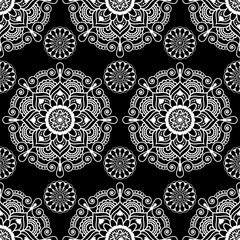 Seamless pattern mandala mehndi floral lace elements of buta decoration items on black background.