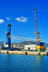 Fototapeta na wymiar Cargo shipping, cranes in Genova industrial port, Italy