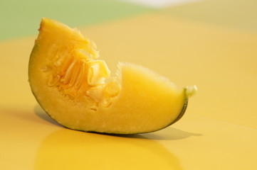 Yellow and ripe pumpkin lie on a bright background