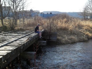 Bridge Fishing/Man sitting on bridge fishing in Michigan
