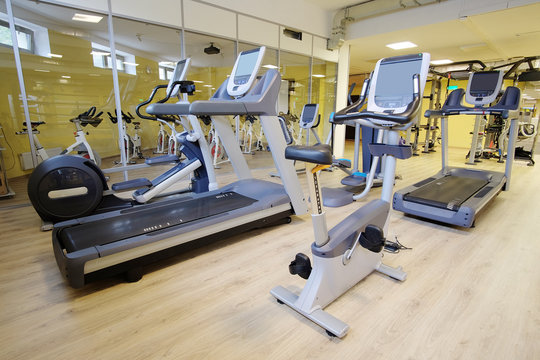 Interior of a modern fitness hall with treadmill