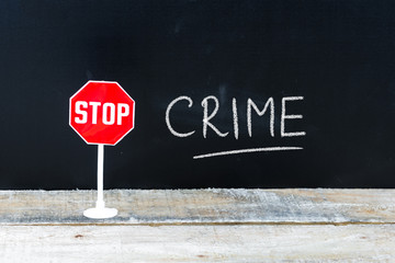 STOP CRIME message written on chalkboard