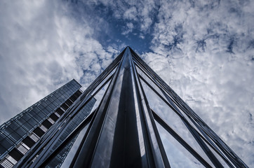 underside panoramic and perspective view to steel blue glass high rise building skyscrapers,...