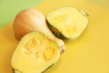 Yellow and ripe pumpkin lie on a bright background. 