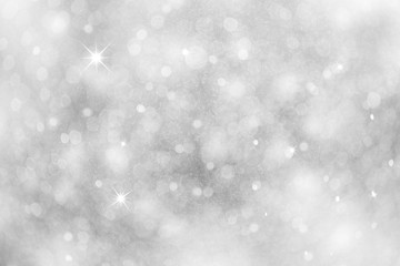 Artistic winter snowfall bokeh background with sparkle. Silver colored blurry Christmas and New...
