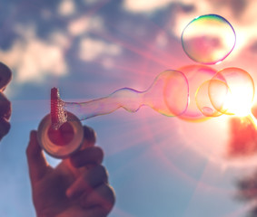 blowing bubbles at sunset. summer romance.