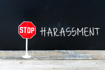 STOP HARASSMENT message written on chalkboard
