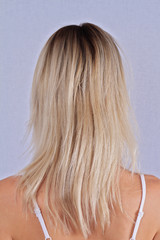 Woman with blonde damaged hair, split ends