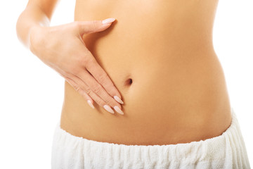 Woman massaging slim belly 