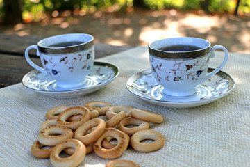 in nature, on the table bagels and cups, in a sunny warm day
