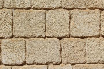 Texture of the stone wall. Yellow stone as modern design of buildings facade.