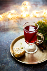 Mulled wine with apples, nuts and spices on copper tray. .