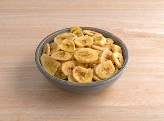 Dried bananas in an old bowl on a table