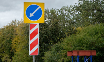 Road sign on the forest background