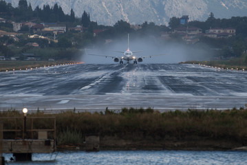 Airplane takeoff on the wet runway in Corfu airport