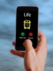 Life alarm on celular phone. Wake up or snooze. Self awareness concept.