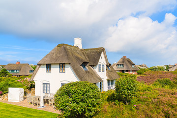 Fototapeta na wymiar Typical Frisian houses with thatched roof on Sylt island in Westerheide village, Germany
