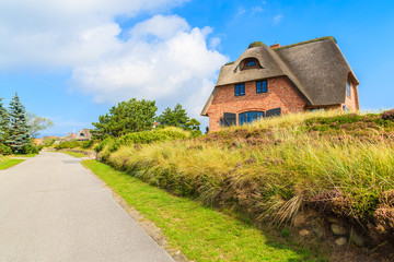 Road in Westerheide village with typical house on side, Sylt island, Germany