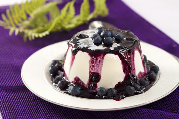 Sweet pudding with blueberry confiture