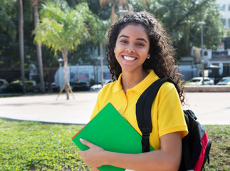 Laughing latin american female student with long dark hair