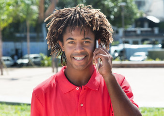 African american guy with amazing hairstyle at phone