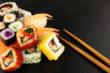 Mixed Sushi Rolls On A Slate Background