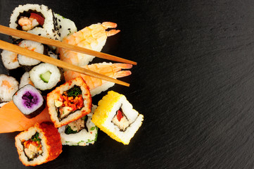 Mixed Sushi Rolls On A Slate Background