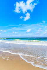 Obraz premium Sea waves on beautiful sandy beach on sunny summer day, Sylt island, Germany
