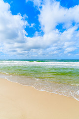 Sea waves on beautiful sandy beach on sunny summer day, Sylt island, Germany