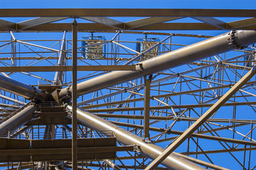 Metalwork details of ferris wheel at the sky background