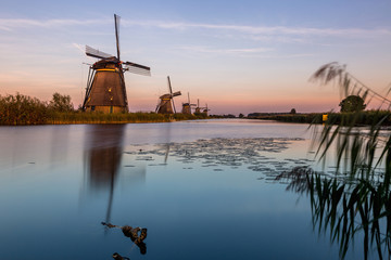 Windmills of Kinderdijk near Rotterdam in Netherlands. Colorful spring scene in the famous Kinderdijk canals with windmills, UNESCO world heritage site