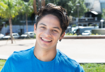 Laughing caucasian guy in a blue shirt