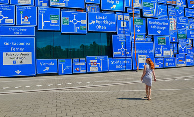 Woman lost her way with a lot of road signs