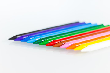 Color palette made with a row of crayons on a white background