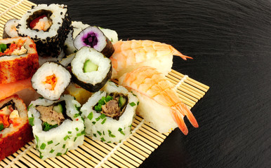 Mixed Sushi Rolls On A Slate Background