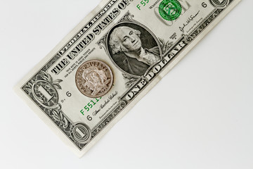 Dollar bill with a coin three Cuban pesos over white background