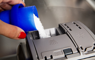 Washer powder pouring into a modern dishwasher