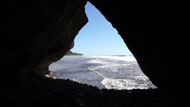 Seashore seen from a small cavern in the rocks, Rurutu island, south Pacific ocean, Austral archipelago, French Polynesia
