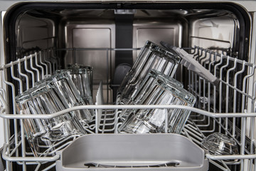 Clean transparent glasses in modern dishwasher machine