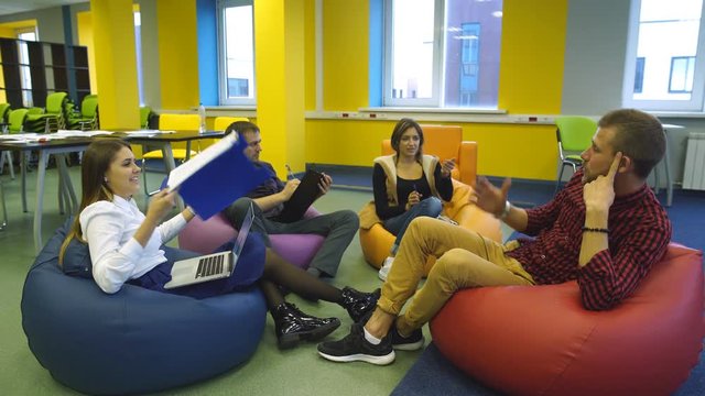 four students sit in the modern class