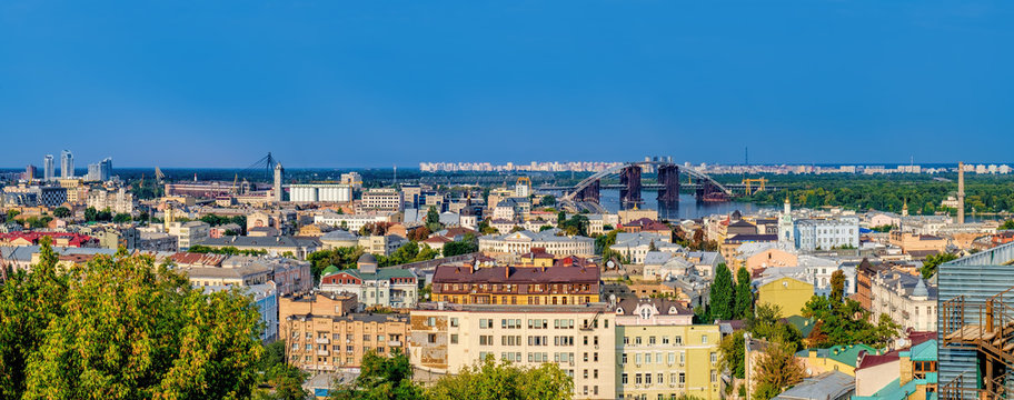 Picturesque view from Zamkova Hill of the National University Of Kyiv-Mohyla Academy, its territory and Havansky Bridge across the Dnieper river. Historical center of Kiev.