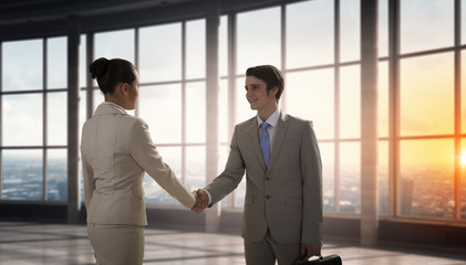 Business partners handshake . Mixed media