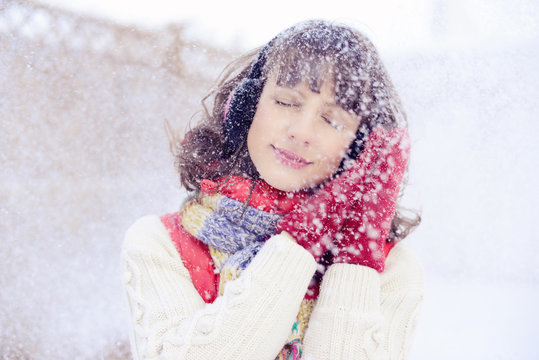 winter portrait of a girl with snow